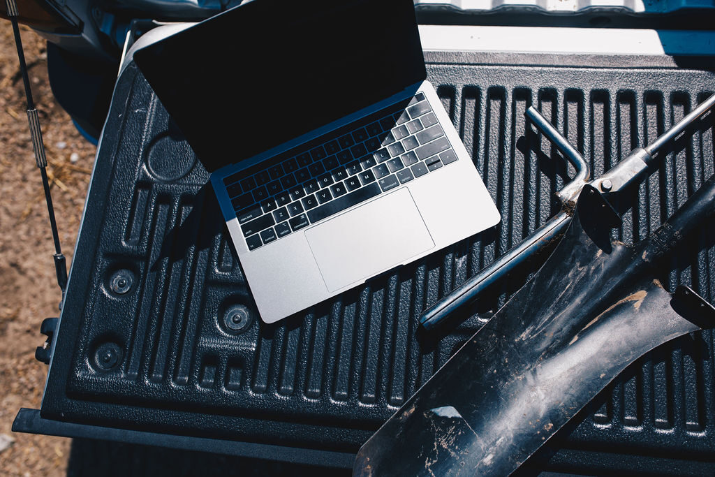 laptop on truck bed in field