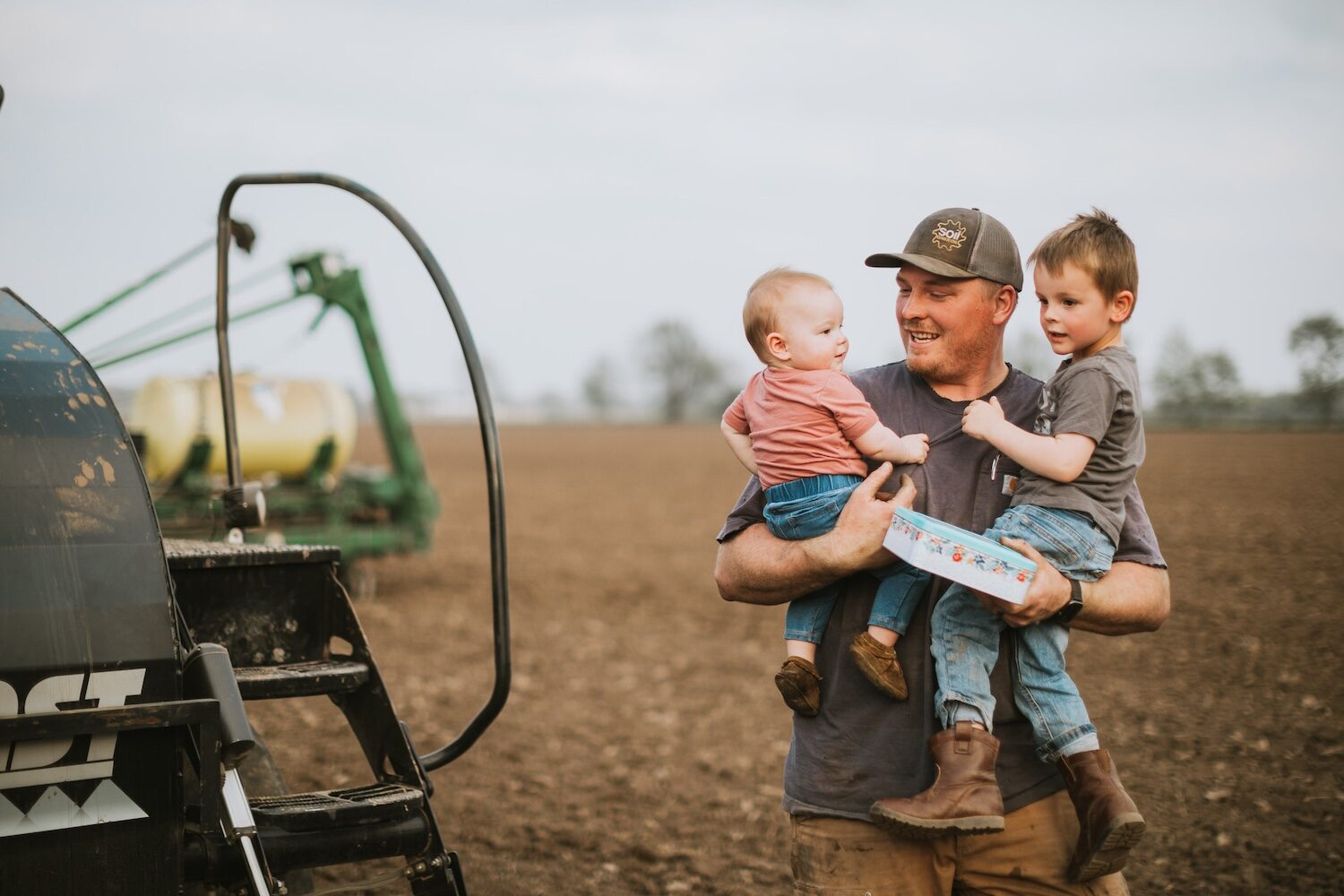 farmer with kids during planting